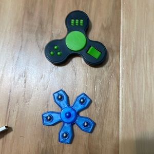 Green and black fidget spinner and blue fidget spinner